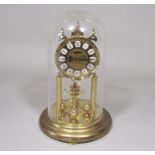Haller brass torsion clock, under a glass dome, 29cm high in total