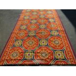 Massive runner or cut of carpet, decorated with geometric Islamic medallions upon a red ground,