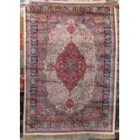 Kashmir rug with intricate scrolled foliage decoration, the central red medallion and birds upon