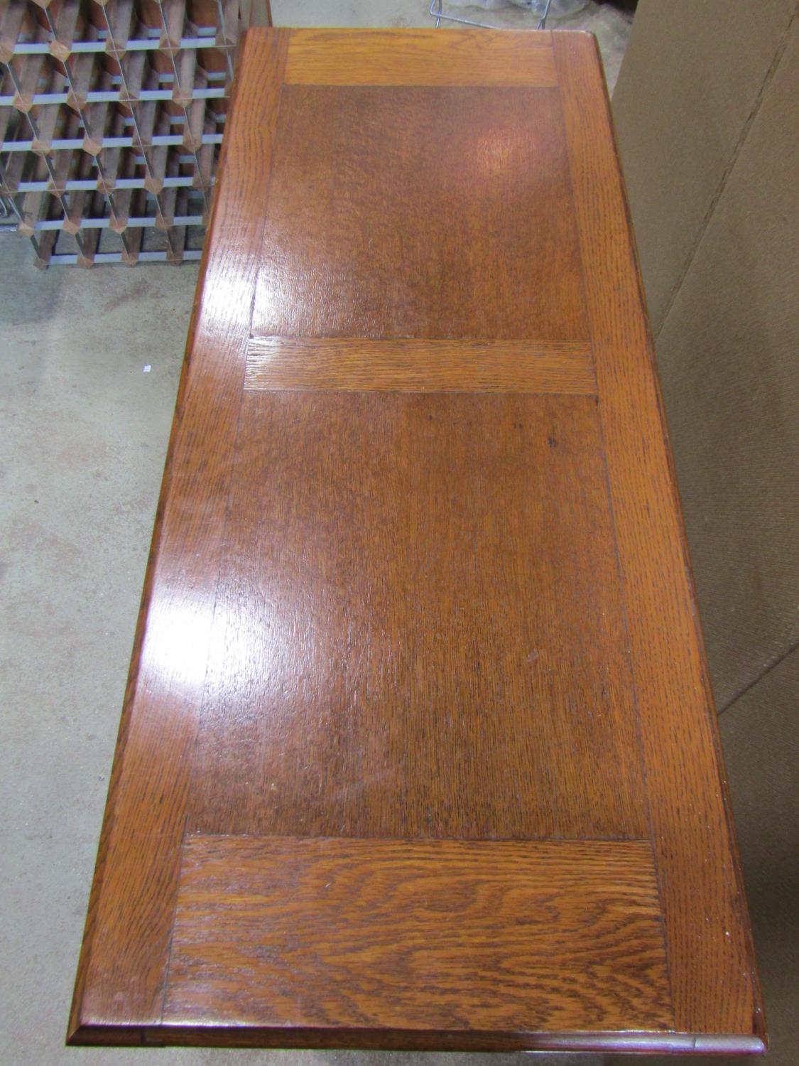 A 1920s narrow oak monks/hall bench, the rectangular sliding top raised on baluster supports over - Image 2 of 5