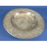 A foreign white metal dish, the wide embossed border with repeating geometric detail, unmarked, 22.