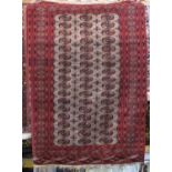 Good quality Bacora rug with central three row geometric medallion design with fawn panel upon a red