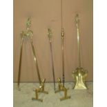 A set of three art nouveau style brass fire irons, a further brass poker and pair of associated dogs