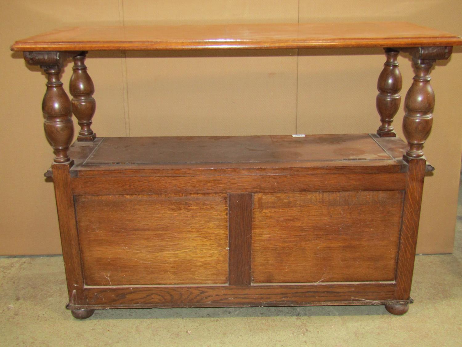 A 1920s narrow oak monks/hall bench, the rectangular sliding top raised on baluster supports over - Image 3 of 5