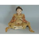 A 19th century Japanese lacquered figure of a seated female, with crossed legs and original