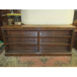 A good quality reproduction Georgian style open bookcase in walnut with reeded columns and ionic