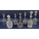 Seven glass decanters to include three graduated bottle neck decanters each etched with geometric