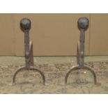 A pair of iron work andirons with hammered mushroom shaped finials