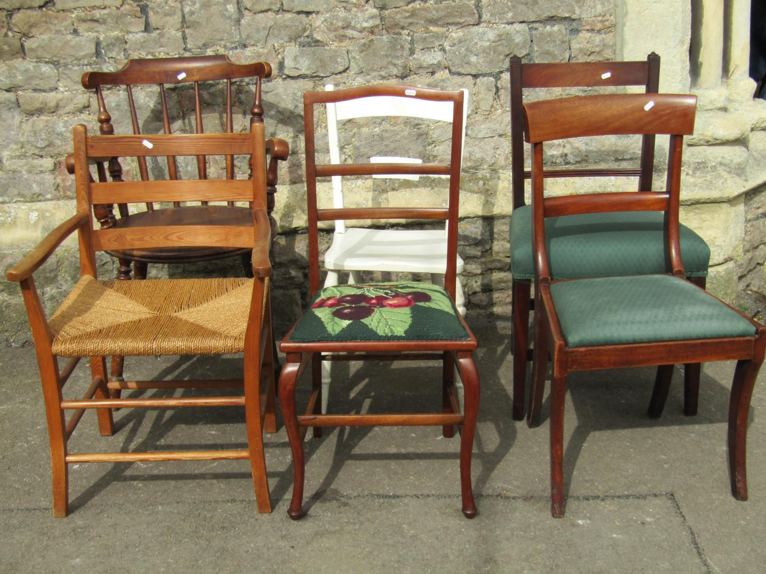 A Swedish stained beechwood stick back elbow chair with circular seat, raised on turned supports (