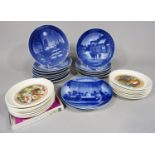 A collection of twelve Royal Copenhagen blue and white printed Christmas plates dating from the
