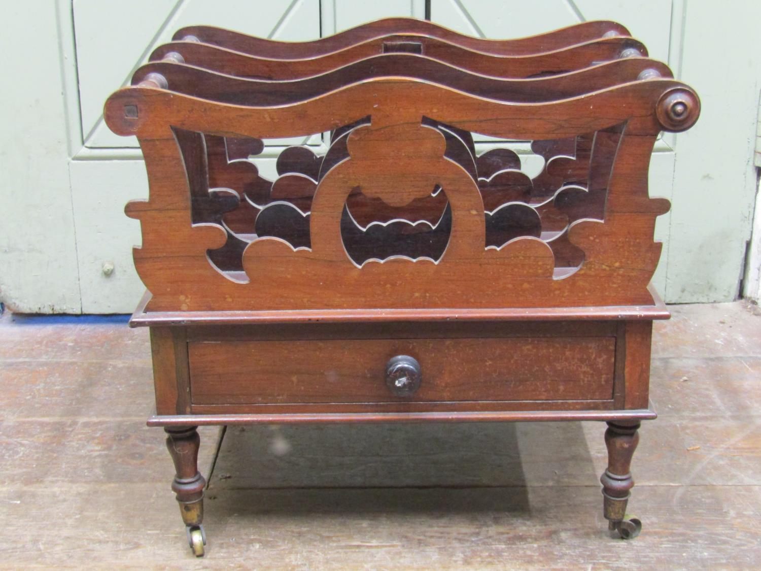 A late Regency rosewood three divisional Canterbury with shaped outline and pierced detail, over a