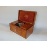 A good quality 19th century figured oak tea caddy of rectangular form, the central cut glass