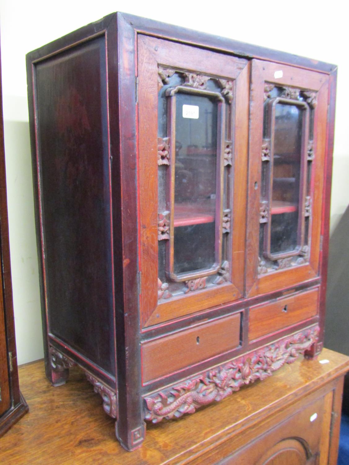A 19th century Chinese side cupboard, enclosed by two glazed panelled doors over two frieze - Image 2 of 6
