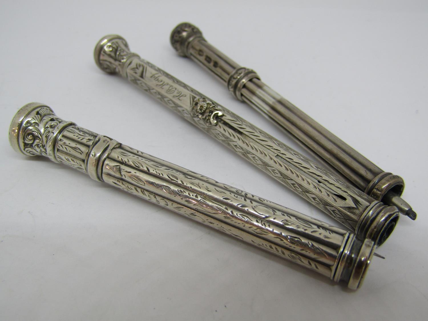 Two Victorian fluted silver propelling pencils, each with bloodstone type knops, together with a