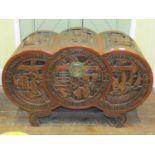 A Chinese camphor wood chest in the form of three concentric circles, with carved detail showing