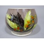 An unusual Moorcroft low vase with painted yellow, brown and orange leaf and berry detail on a