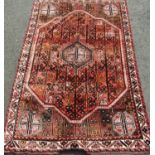 Persian Quashqui tribal full pile carpet with unusual bespoke design upon a washed red ground, 260 x
