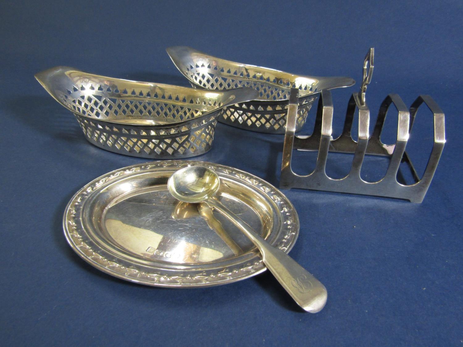 A collection of silver comprising a pair of oval bonbon dishes with pierced diaper raised rims,