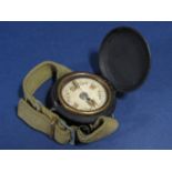 Ebonised military pocket compass, in a hunter type framework and canvas wrist strap, 46 mm case