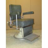 A vintage swivel and adjustable opticians chair with faux leather upholstered seat, back and arms,