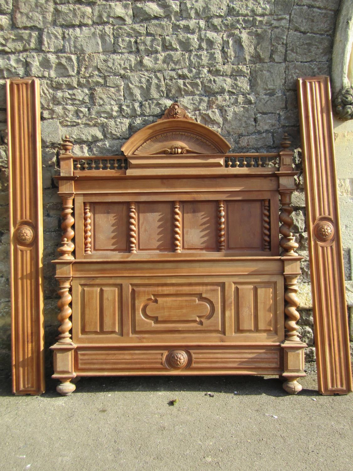 A 19th century continental bedstead in mixed woods, mainly fruitwood and chestnut, the headboard