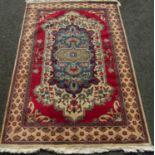 Turkish/Caucasian type carpet with floral central medallion and red field upon a cream ground, 280 x