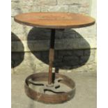 An industrial style steam punk bistro table, the circular pine segmented top with iron rim, raised