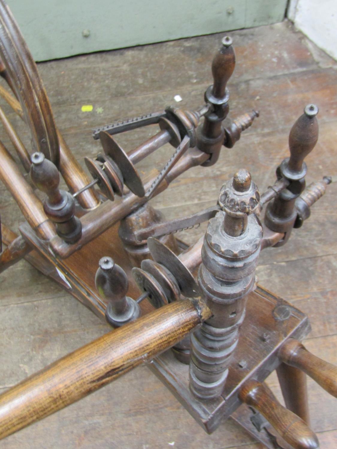 An antique spinning wheel in mixed woods including elm and beechwood, with turned spindles, 110cm - Image 3 of 3