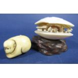 Chinese carved ivory clam, decorated with figures in an exterior scene upon an organic wooden plinth