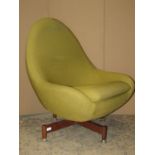 Two similar mid-20th century swivel egg type chairs with shaped outline, raised on sprung and