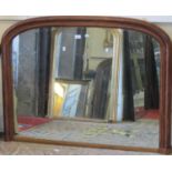 A Victorian overmantle mirror, with stained moulded arched frame with egg and dart and dentil