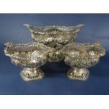 Garniture of pierced and embossed silver baskets with floral C scroll and
