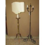 A ironwork three branch standard lamp with scrolled tripod supports together with a giltwood