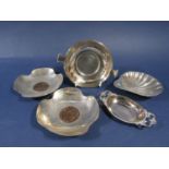 A good mixed lot of silver dishes to include a scallop shell, a small twin handled pin tray, two