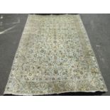 A large Axminster type carpet with yellow and blue scrolled foliage upon a pale ground, 390 x 265 cm