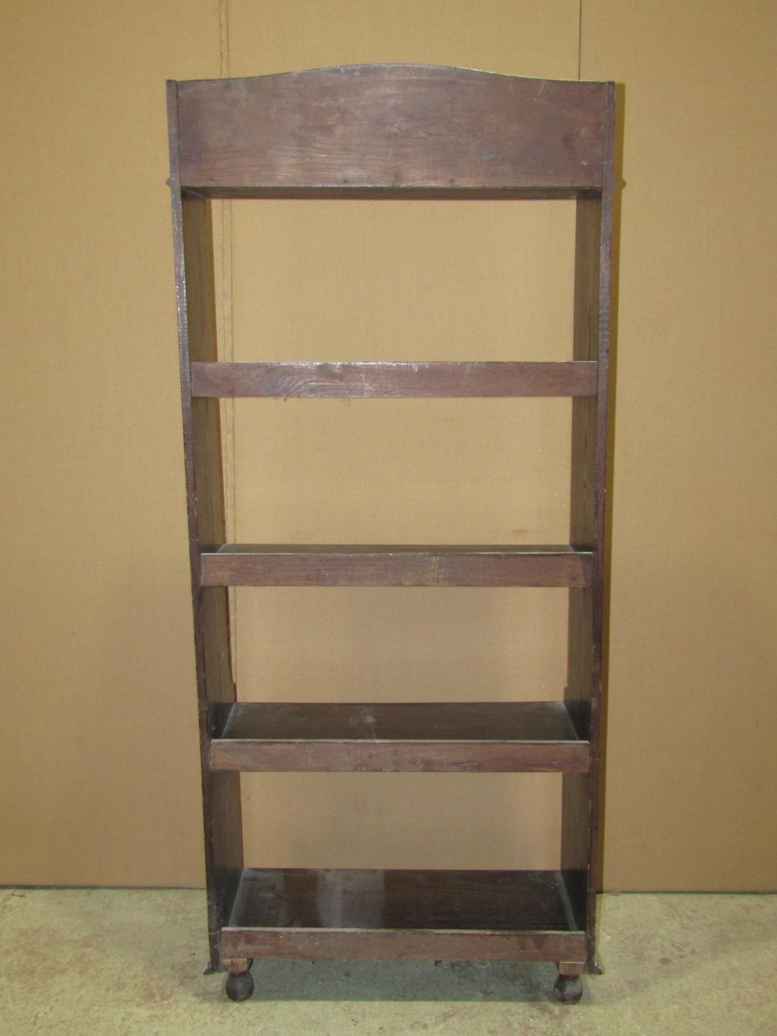 A 1920s oak freestanding open bookcase with fixed shelves, the upper with bow front and appllied - Image 4 of 4