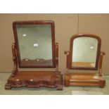 A Victorian mahogany toilet mirror, the rectangular plate with moulded frame raised on scrolled