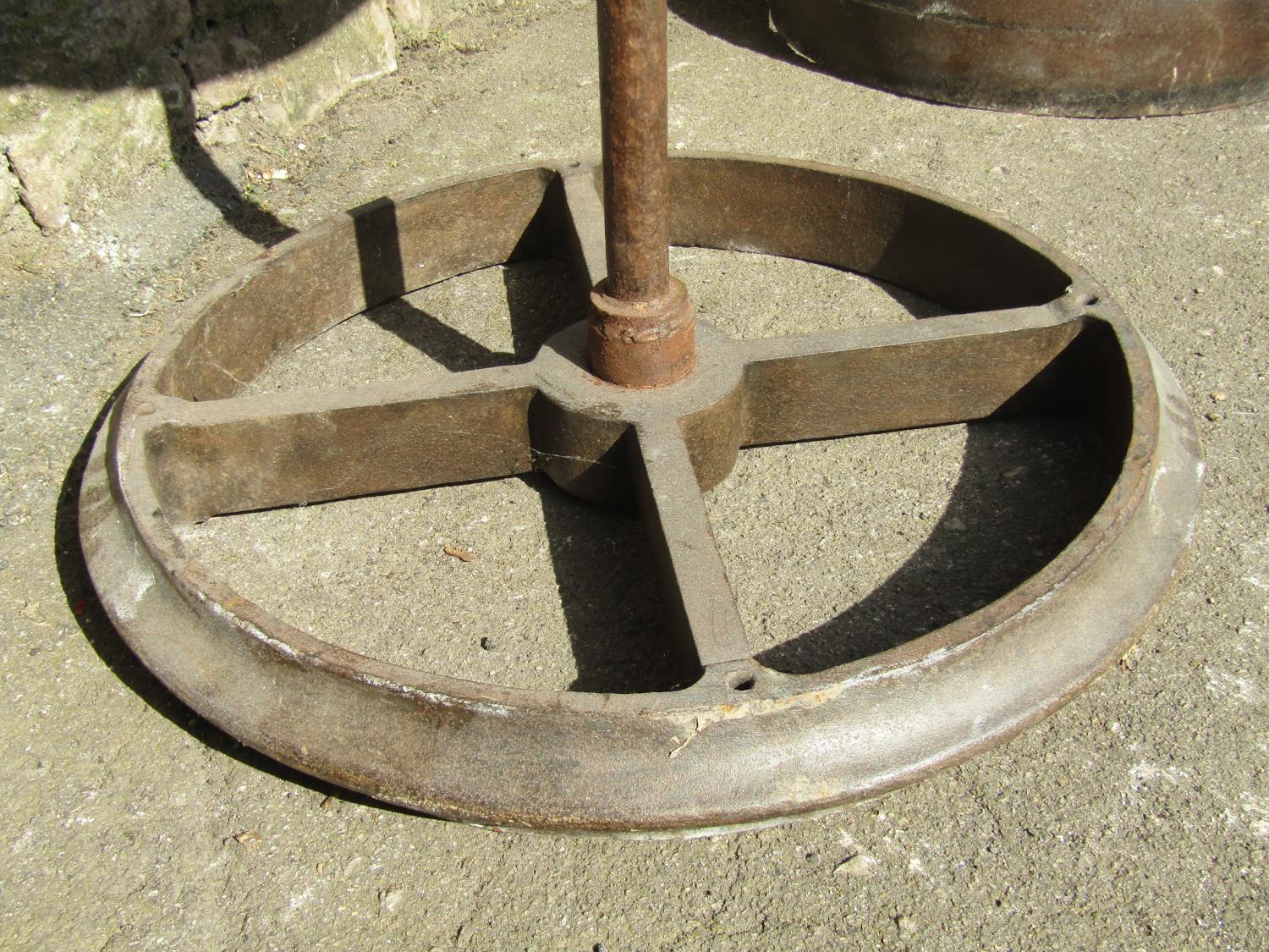 An industrial style steam punk bistro table, the circular pine segmented top with iron rim, raised - Image 2 of 3