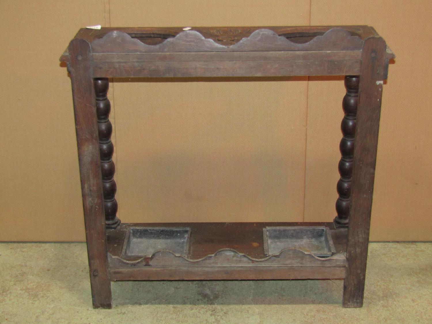 A Victorian Gothic carved oak umbrella/stick stand, with two oval cut out divisions and turned - Image 2 of 3