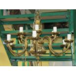 A cast brass six branch chandelier supporting twelve sconces with scrolled and other detail, 60 cm