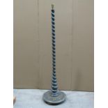 An Edwardian/1920s wooden standard lamp with spiral twist column and moulded disc shaped base, and