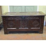 A late 17th century oak coffer, the front elevation with repeating carved detail within chequered