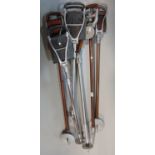 Six shooting sticks with adjustable frames, many with leather seats