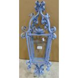 A hall or porch lantern of square tapered form the decorative painted ironwork frame with scroll