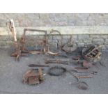 A collection of antique agricultural related ironwork etc to include a trap, branding iron, spiked