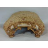 A Regency period footstool with arched outline, the carved timber ends, with original painted