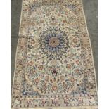 A good quality Tabriz Persian rug, with central floral medallion flamed by further blue scrolled