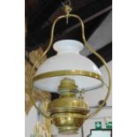 A Victorian brass celling oil lamp, with opaque white glass shade, later adapted for electricity and