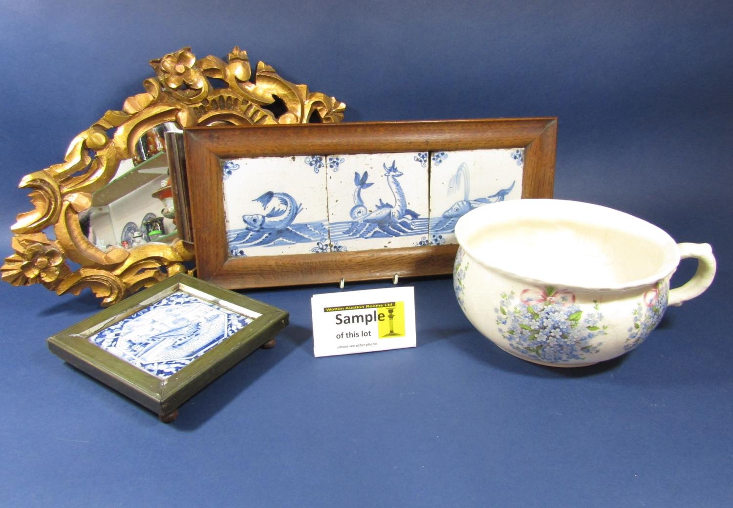 A set of three early 19th century Delft type blue and white tiles with painted fish and sea