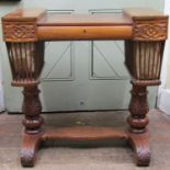 A late Regency mahogany ladies writing/sewing table of unusual form, the central section enclosing